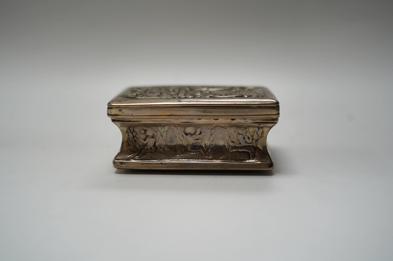 A late 19th century Dutch embossed white metal rectangular snuff box, 83mm, 107 grams. Condition - poor